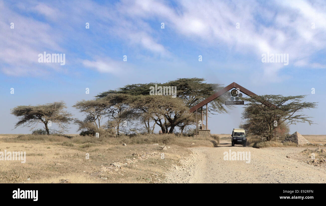 The entrance gate at Serengeti National Park, Tanzania, with a car along the road. Stock Photo