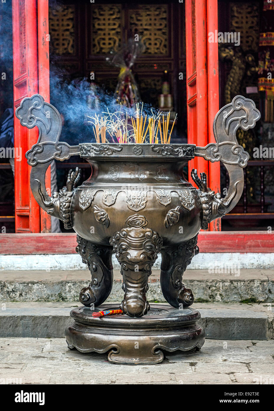 Three legged offer vase with burning incense at Ngo-Son temple in Hoan Kiem Lake. Stock Photo