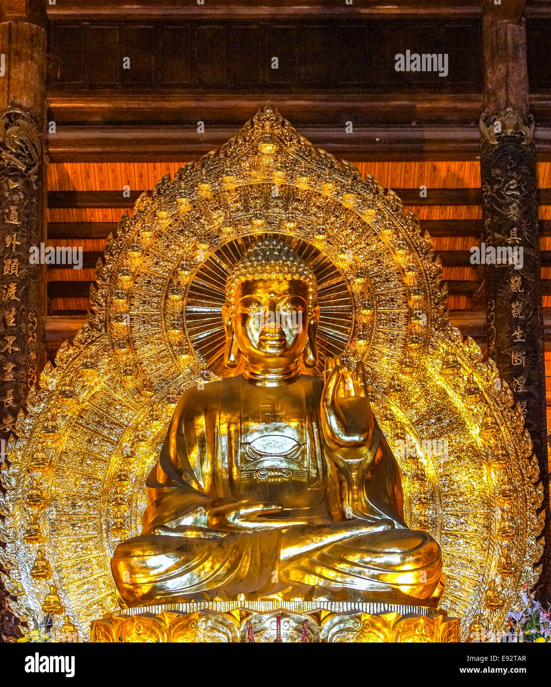 Framed giant golden Buddha image greets visitors. Stock Photo