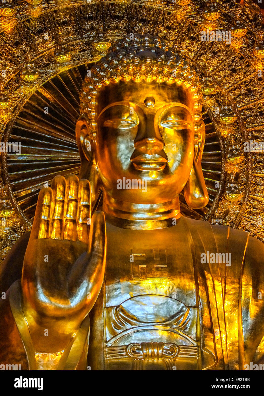 Frontal view of Buddha face, hand gesture and bust. Stock Photo