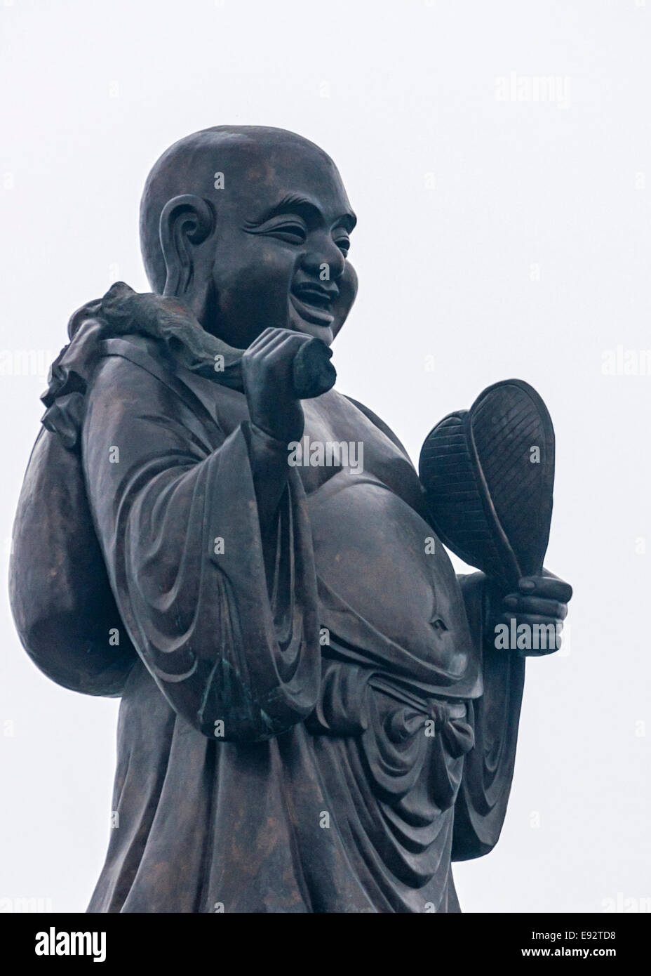 36 Ton granite statue of happy wandering Buddha. Stock Photo