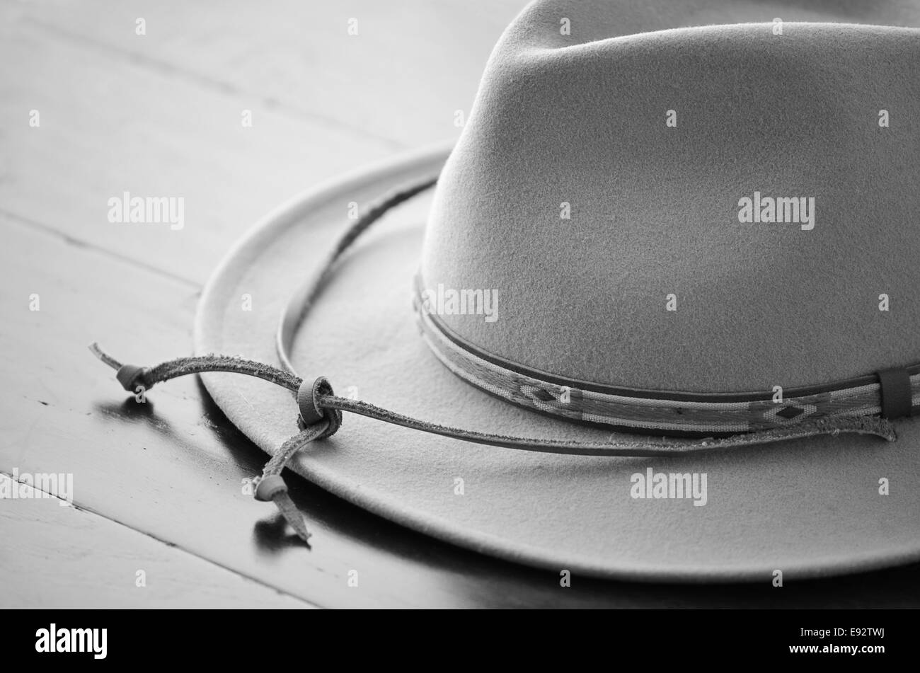 Cowboy hat in black and white on wooden background in horizontal format with selective focus Stock Photo