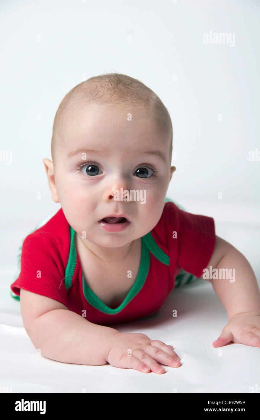 9 month old baby boy holding his head up wearing Christmas colors colours Stock Photo