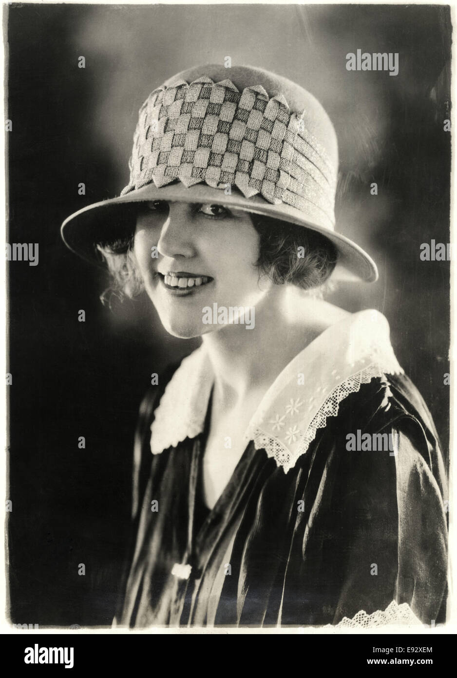 Smiling Woman in Sports Hat of Felt and Straw Braid, Close-Up Portrait, circa 1922 Stock Photo