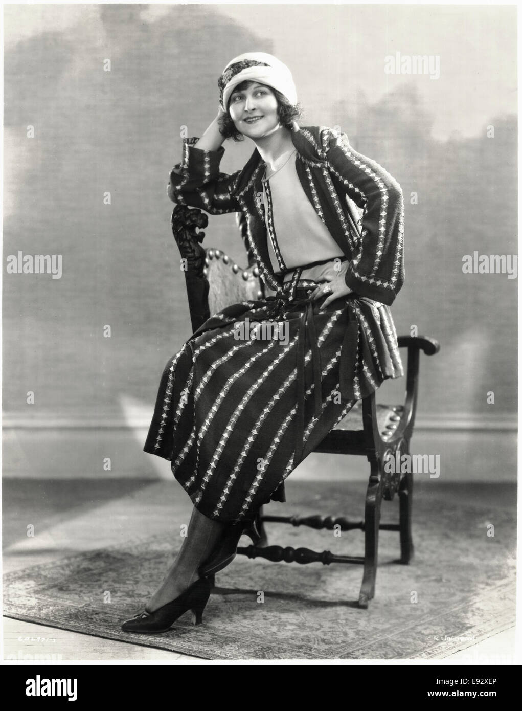 Seated Fashionable Woman in Three-Piece Outfit and Hat, Portrait, circa 1922 Stock Photo
