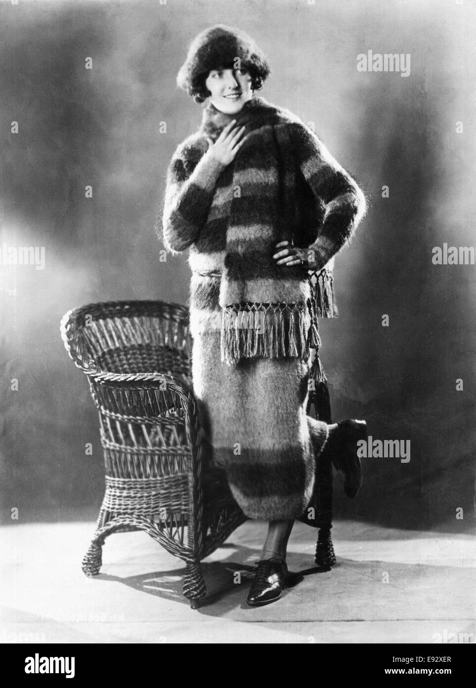 Fashionable Young Woman in Skating Outfit Consisting of Matching Sweater, Skirt, Scarf and Hat Made of Angora Wool, Portrait, circa 1922 Stock Photo