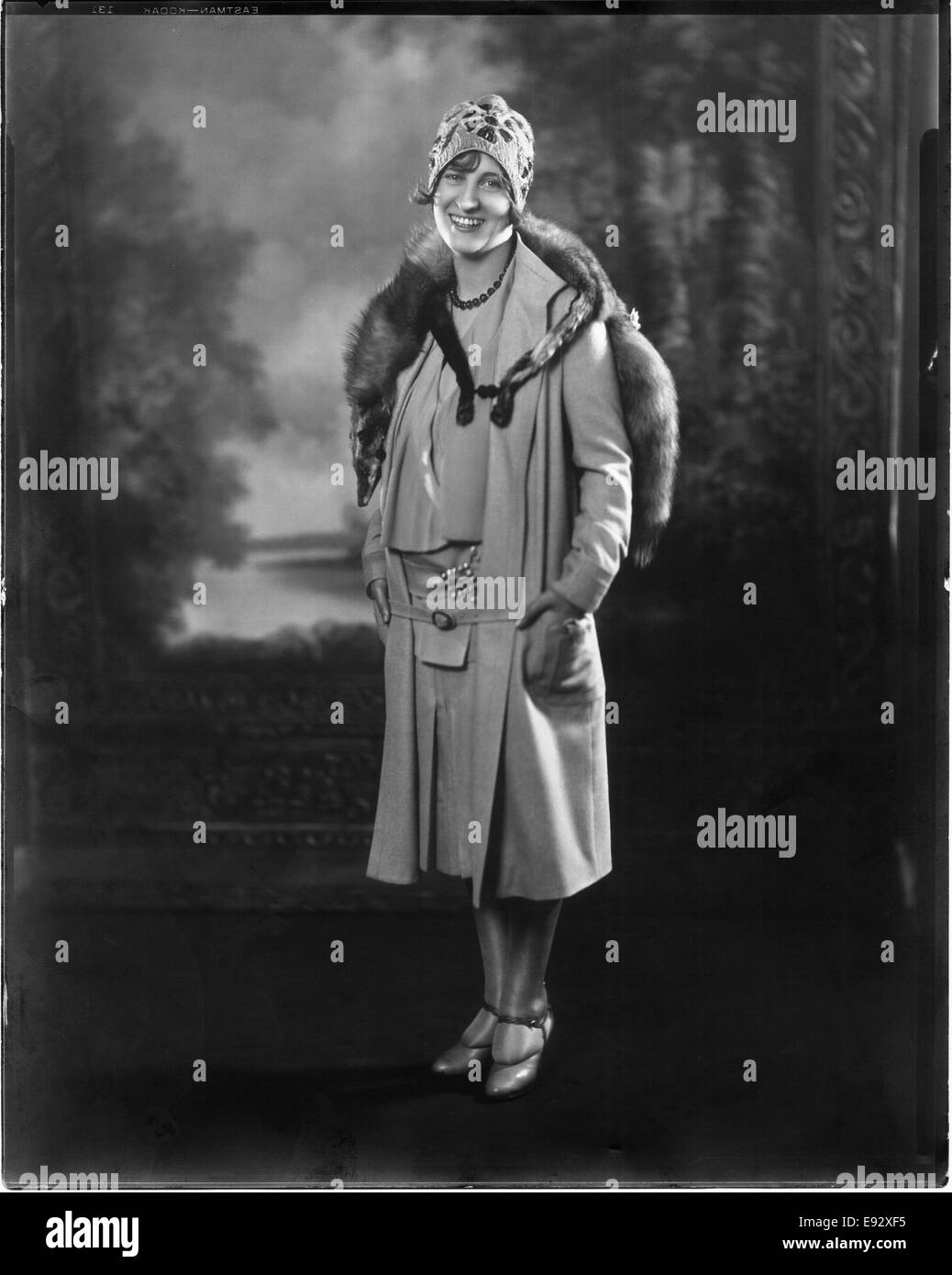 Fashionable Woman in Short Dress and Coat with Mink Fur Stole and Knit Cap, Portrait, circa 1923 Stock Photo