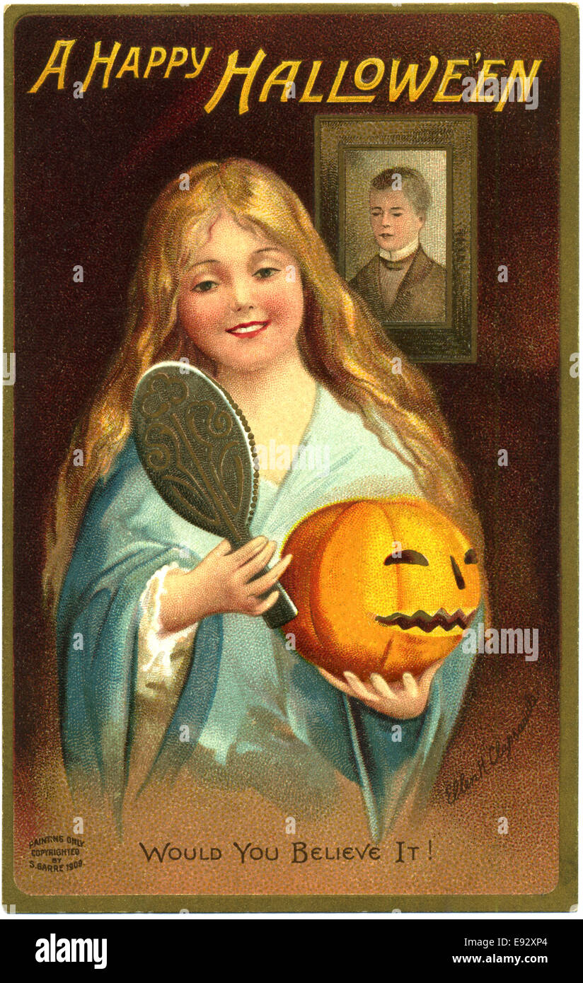 Girl Holding Jack-o-Lantern and Mirror, 'A Happy Hallowe'en, Would you believe it', Postcard, circa 1909 Stock Photo
