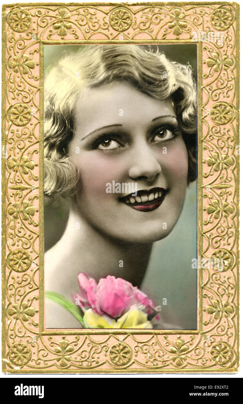 Smiling Blonde Woman with Rose, Framed, Hand-Colored Postcard, circa 1910's Stock Photo