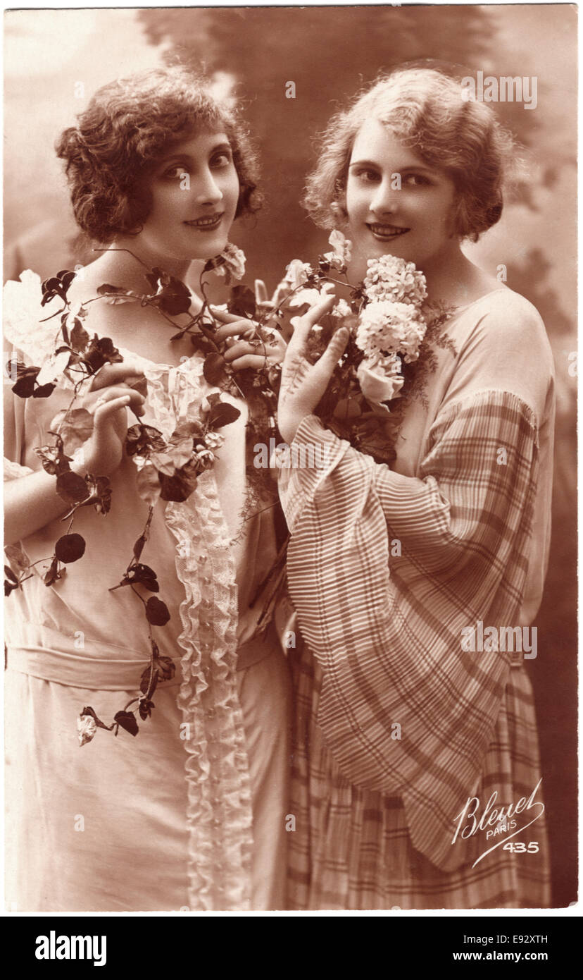 Two Smiling Women with Flowers, Portrait, French Postcard, circa 1910's Stock Photo