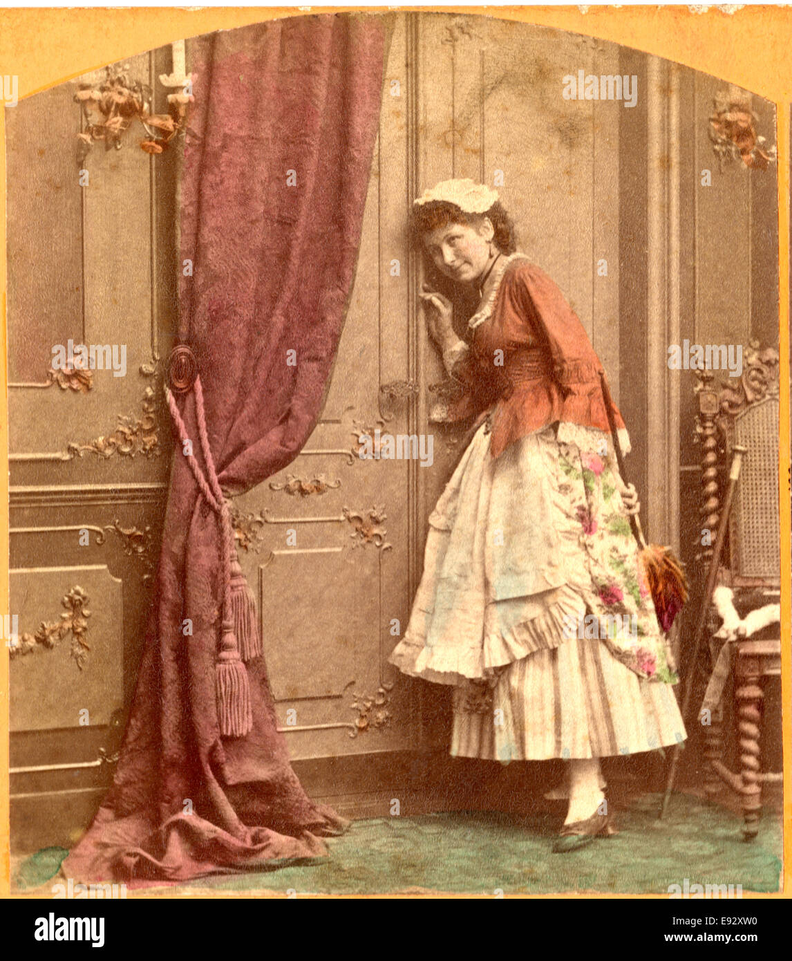 Maid with Feather Duster Eavesdropping at Door, Single Image of Stereo Card, circa early 1900's Stock Photo