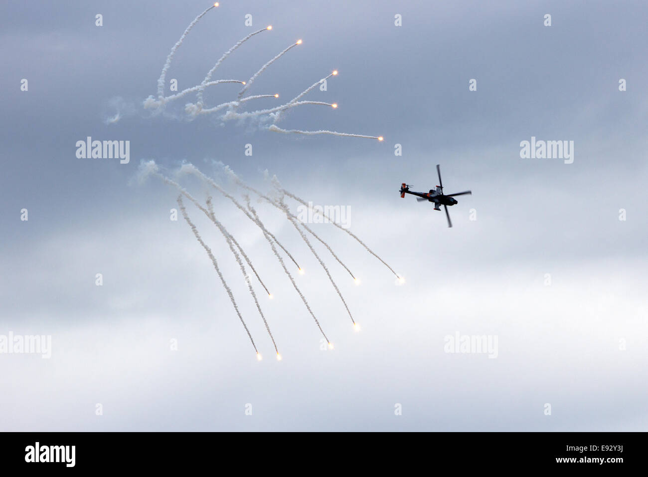 AH-64 Apache attack helicopter firing off flares Stock Photo