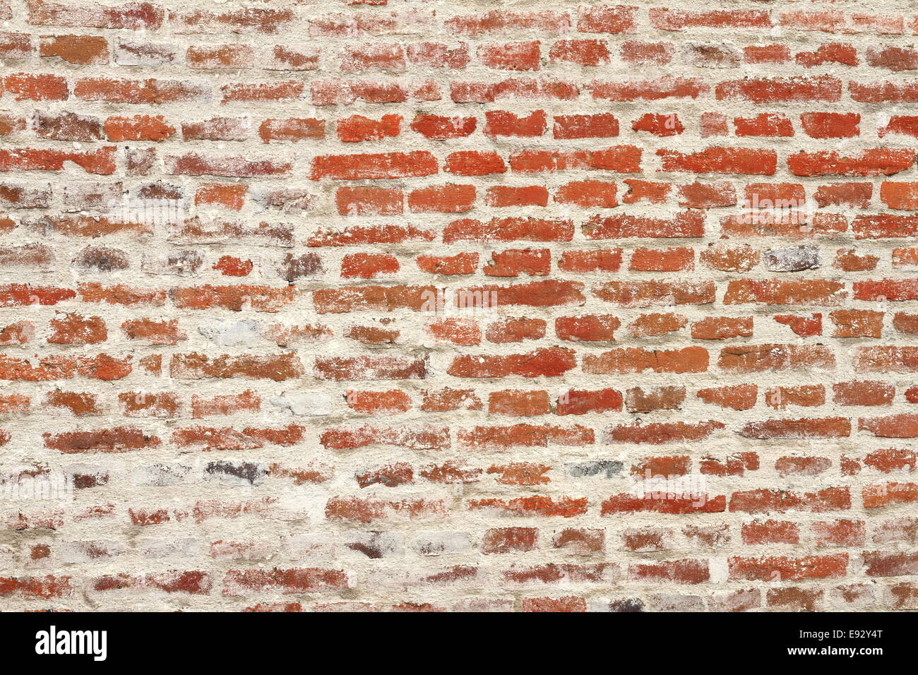 weathered red brick wall, texture on exterior of old castle Stock Photo