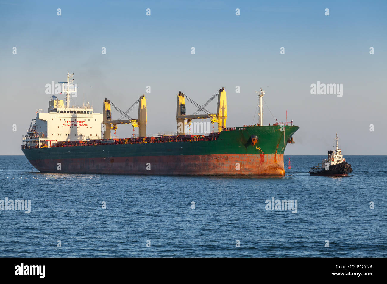 Bulk carrier and small tug boat in the Black Sea Stock Photo