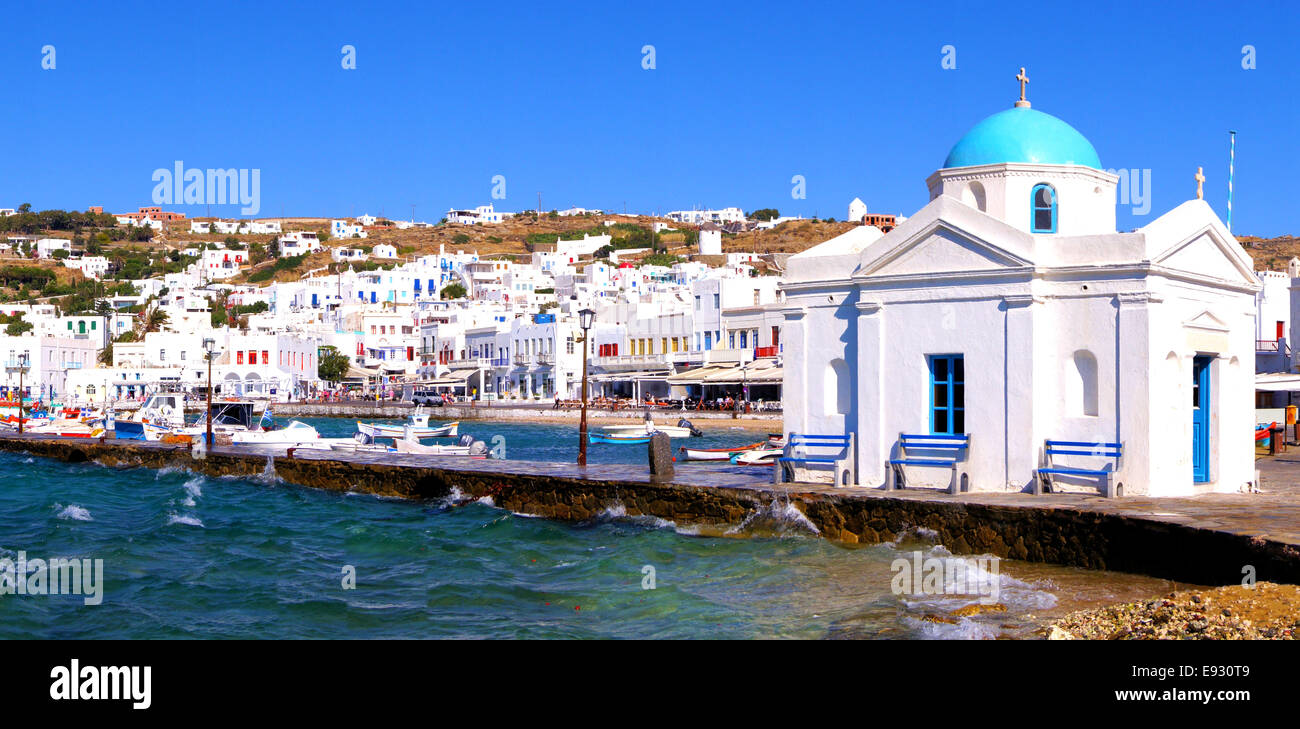 Panoramic view of Mykonos harbor with traditional blue dome church, Greece Stock Photo