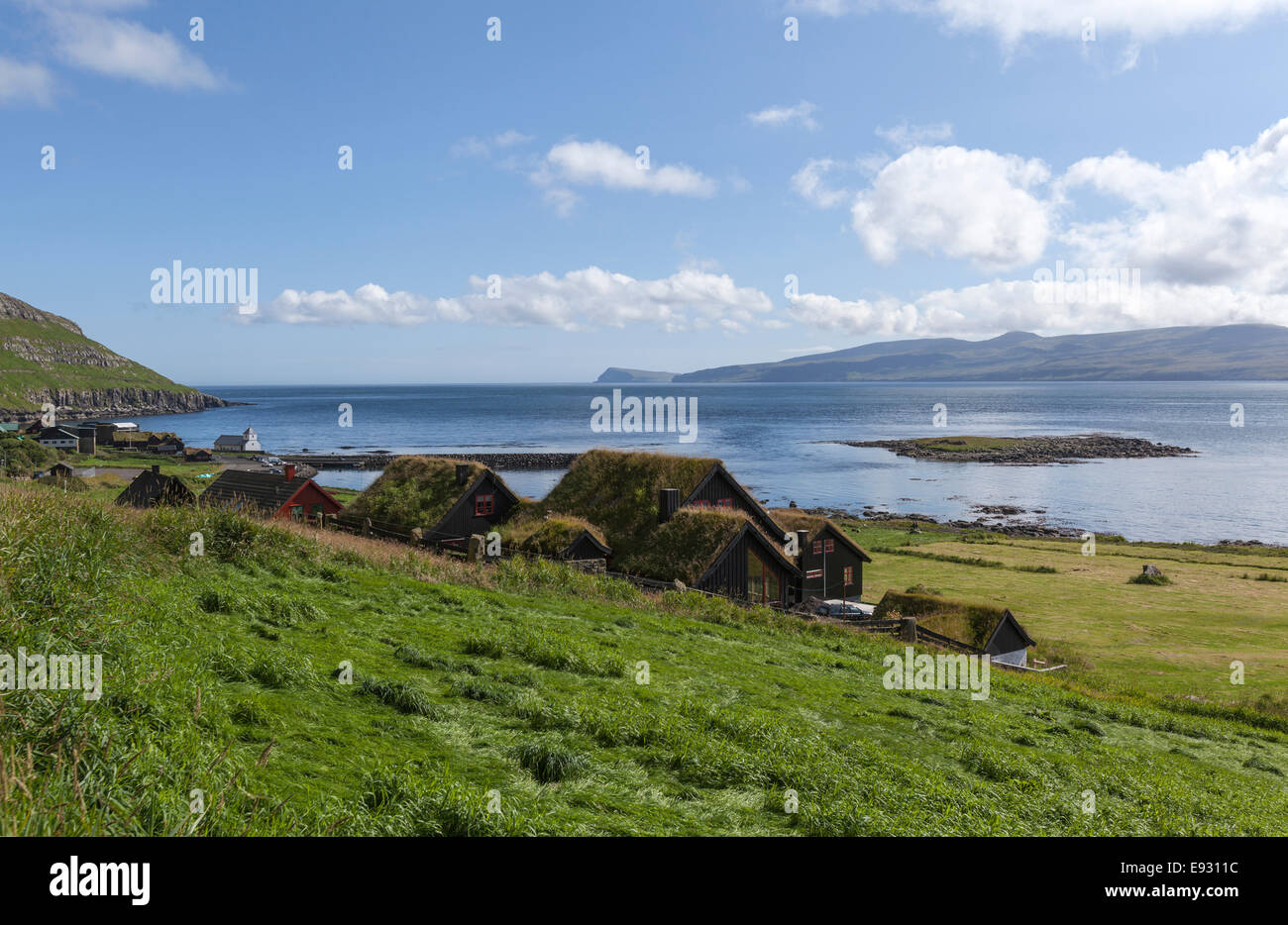 Colorful  and photogenic wooden houses with roof turf covered  in Kirkjubøur, Streymoy island, Faroe Islands, Stock Photo