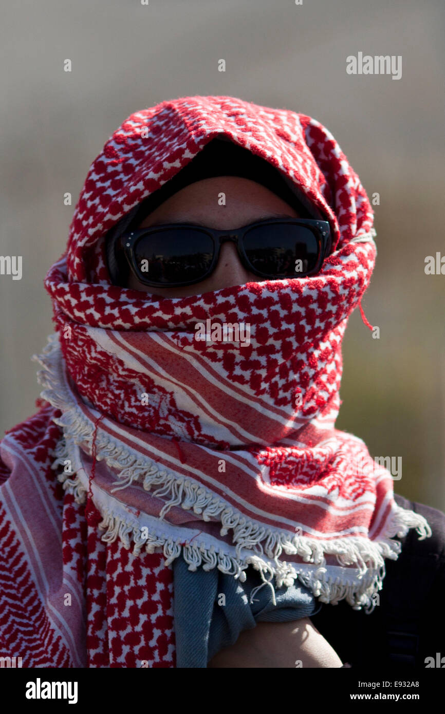 Masked Palestinian demonstrator against the massive Israeli attacks on ...