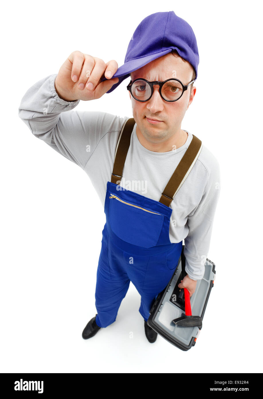 Wide angle view of an awkward repairman with hammer and toolbox Stock Photo