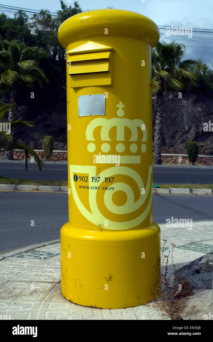 Yellow free standing postbox in Nerja, Spain Stock Photo
