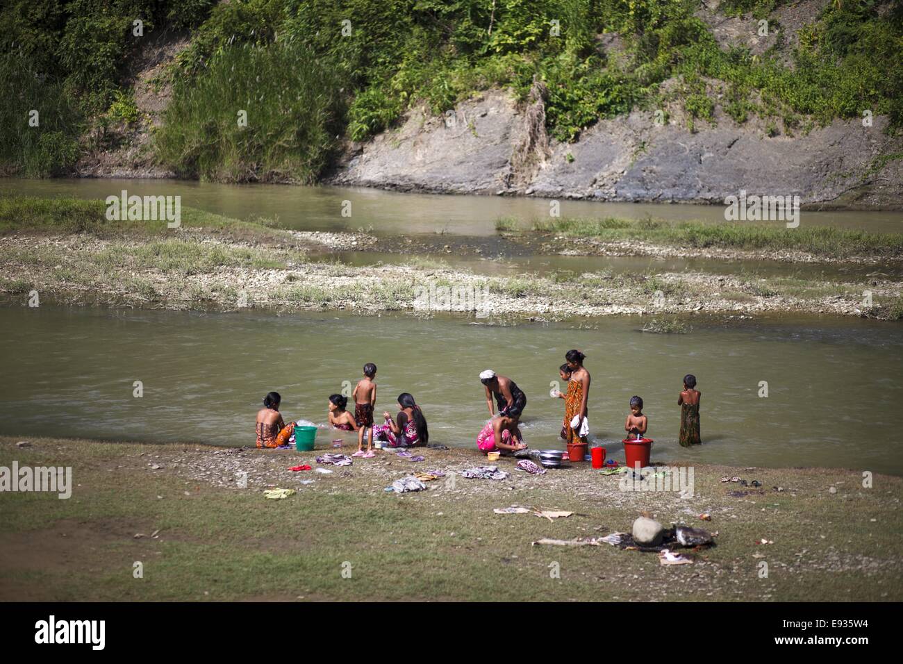 Oct. 10, 2014 - October 10, 2014 - Bandarban, Bangladesh - Marma community people take bathing Sangu river in Bandarban, Bangladesh. Bandarban is a district in South-Eastern Bangladesh, and a part of the Chittagong Division. It is one of the three districts that make up the Chittagong Hill Tracts, the others being Rangamati District and Khagrachhari District. Bandarban is regarded as one of the most attractive travel destinations in Bangladesh. Bandarban (meaning the dam of monkeys), or in Marma or Arakanese language as ''Rwa-daw Mro'' is also known as Arvumi or the Bohmong Circle (of the rest Stock Photo