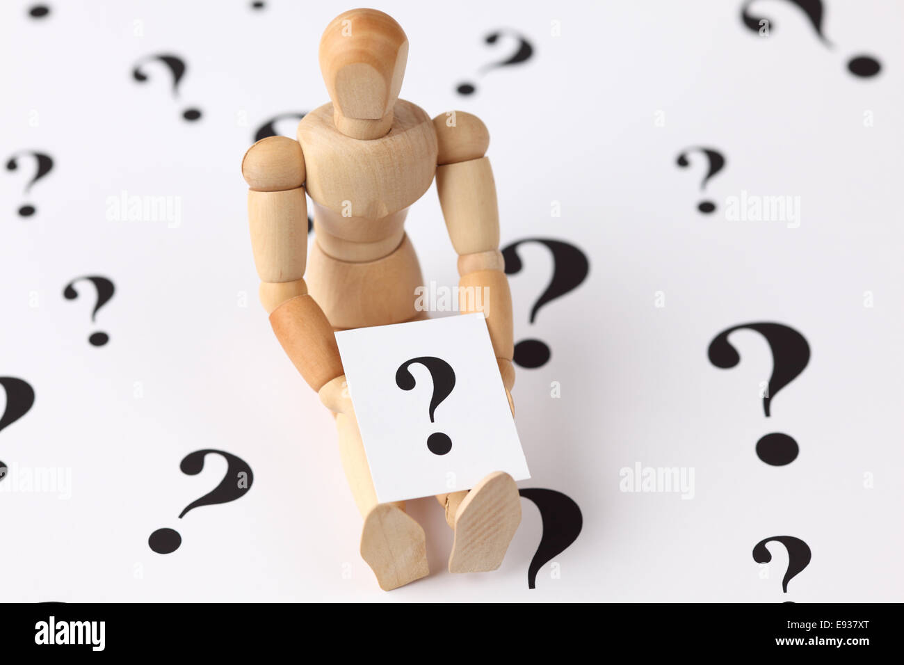 A wooden mannequin holds a question mark Stock Photo Alamy