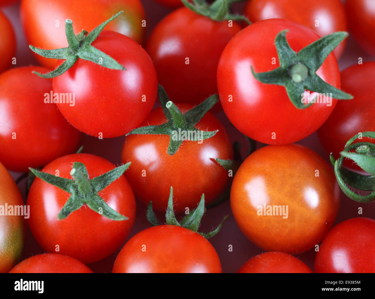 Cherry tomatoes background Stock Photo - Alamy