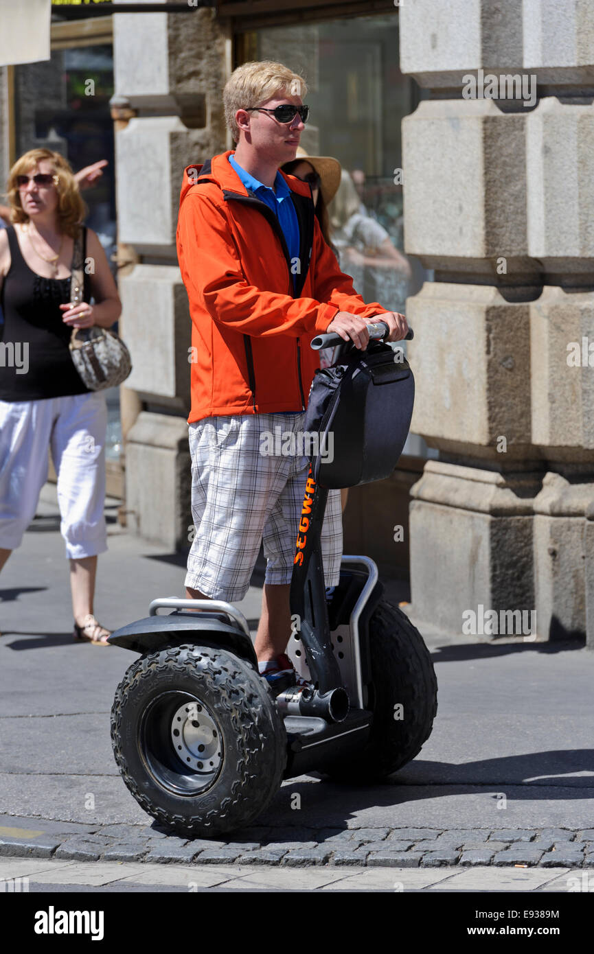 A young man on a two wheeled motorized Segway on the street of Prague, Czech Republic. Stock Photo