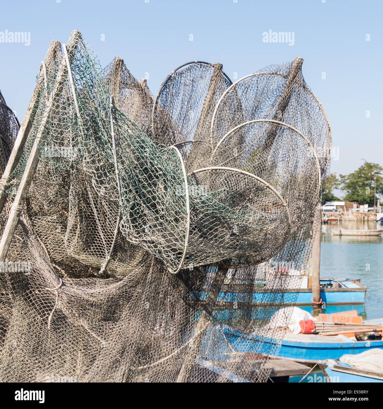 fishing nets, creels and fishing boats in the lagoon. Marano - Italy Stock Photo