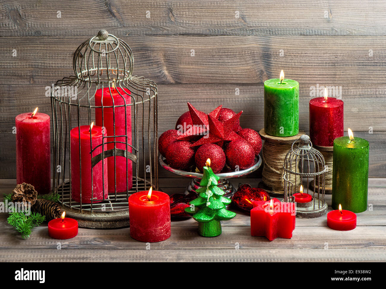 vintage christmas background with birdcage, burning candles and baubles. nostalgic home interior decoration Stock Photo