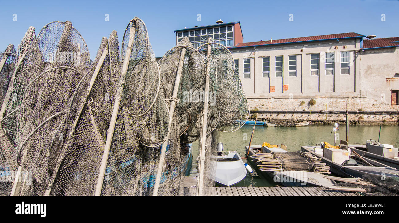 fishing nets, creels and fishing boats in the lagoon. Marano - Italy Stock Photo
