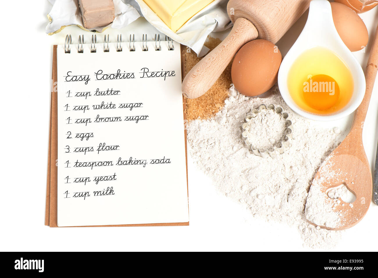 recipe book and baking ingredients eggs, flour, sugar, butter, yeast. food background. Sample text Easy Cookies Recipe Stock Photo