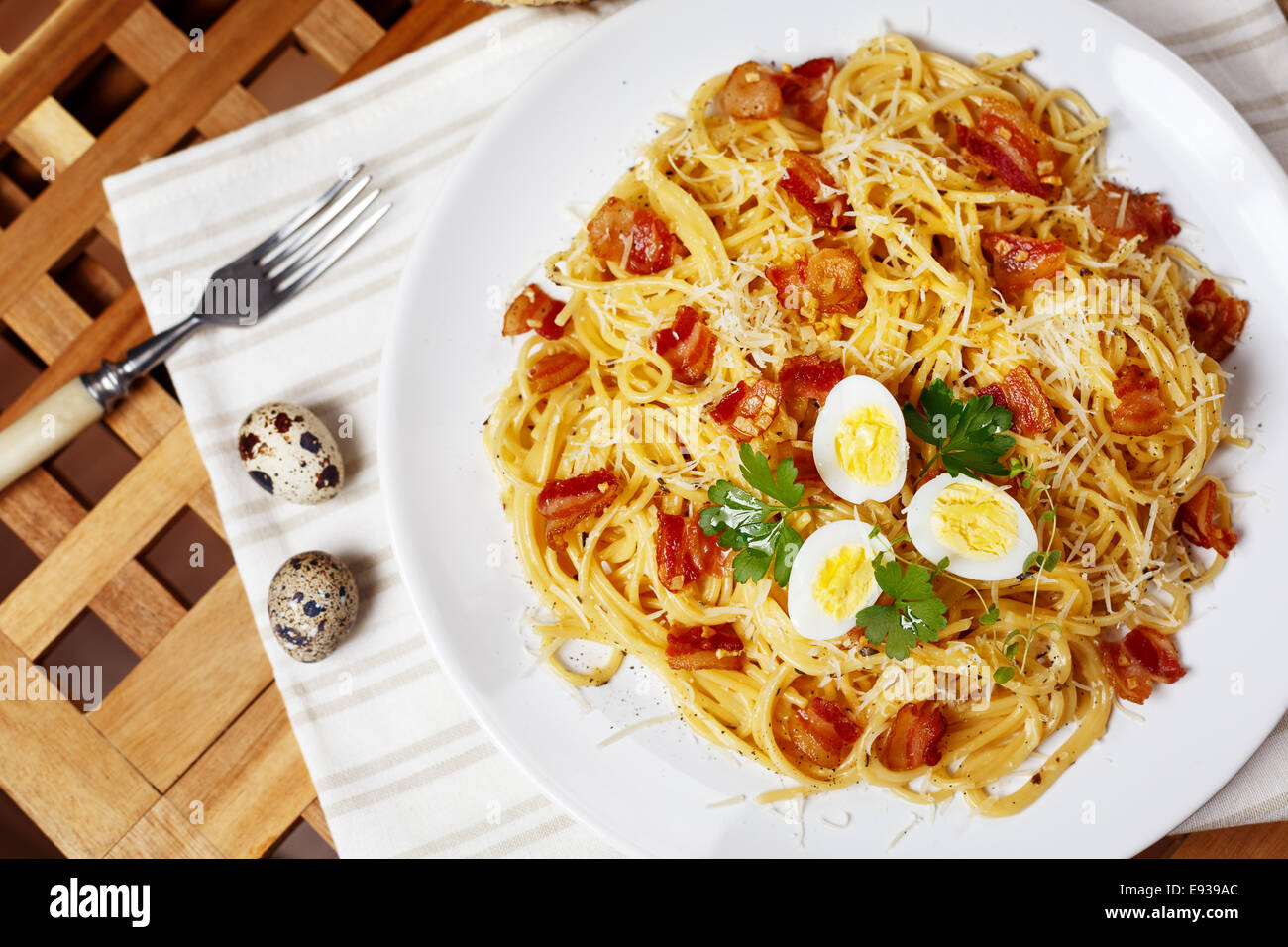 Pasta. Spaghetti with carbonara sauce, parmesan cheese, bacon and quail