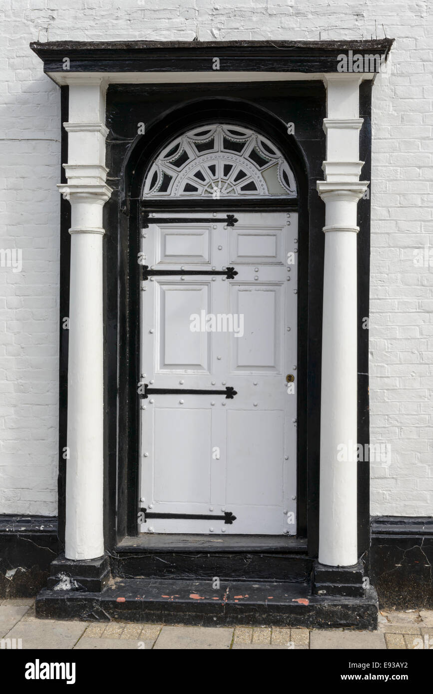 white and black classical door with columns shot in touristic village on river Thames Stock Photo