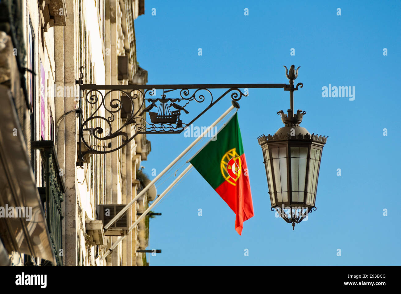 Horizontal view of a decorative wrought iron light and the national flag on the side Stock Photo