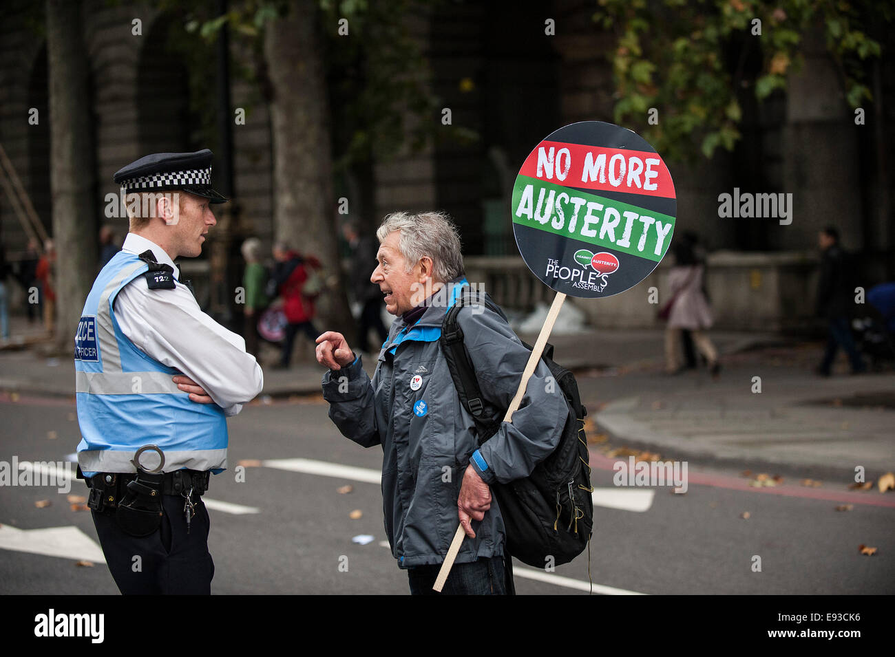 London, UK. 18 October 2014. 'Britain Needs A Payrise'   A TUC national demonstration in Central London.  A protester makes a point to a Police Liaison Officer as the march prepares to set off from the Embankment. Photo: Gordon Scammell/Alamy Live News Stock Photo