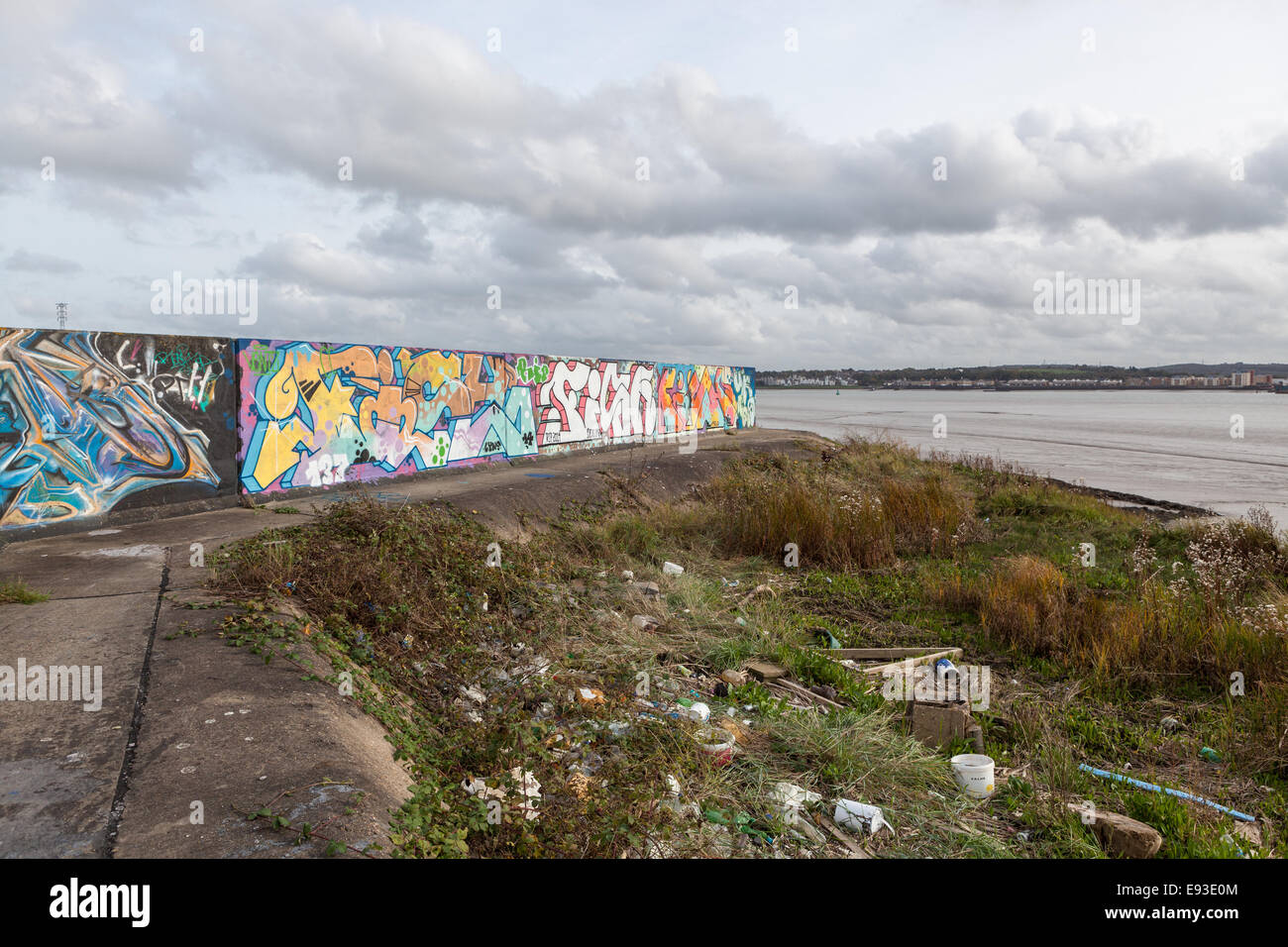 Graffitied flood defences on Thames Estuary Stock Photo