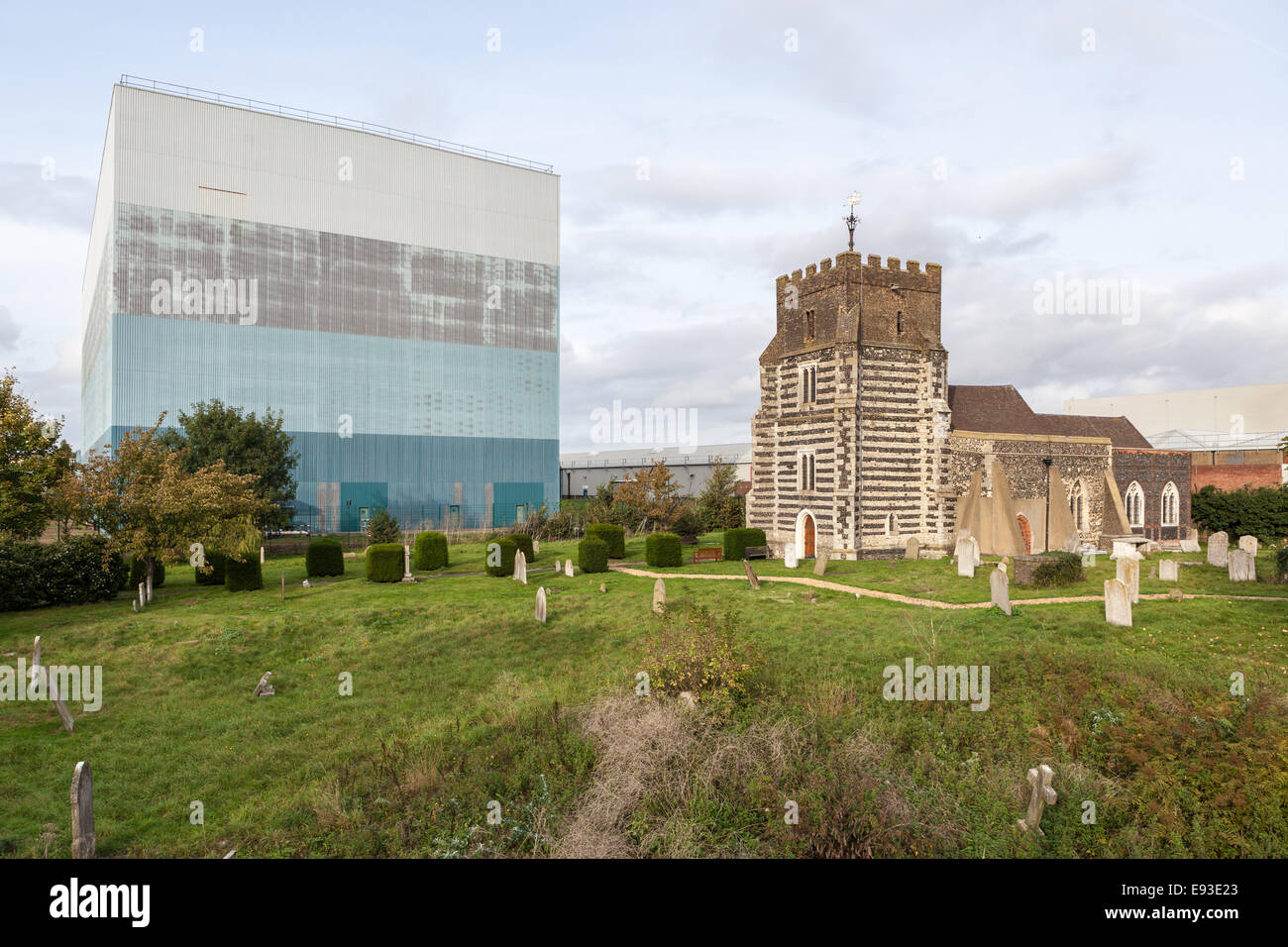 St Clement's Church next to Procter & Gamble building in West Thurrock, Essex, England. Stock Photo