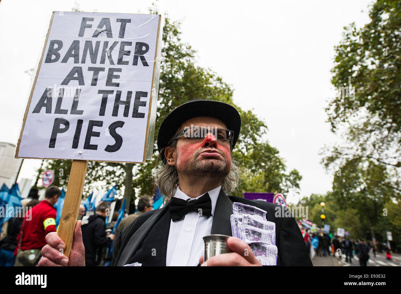 London, UK. 18 October 2014. 'Britain Needs A Payrise'   A TUC national demonstration in Central London.  A protester holds a placard as the march prepares to set off from the Embankment. Photo: Gordon Scammell/Alamy Live News Stock Photo