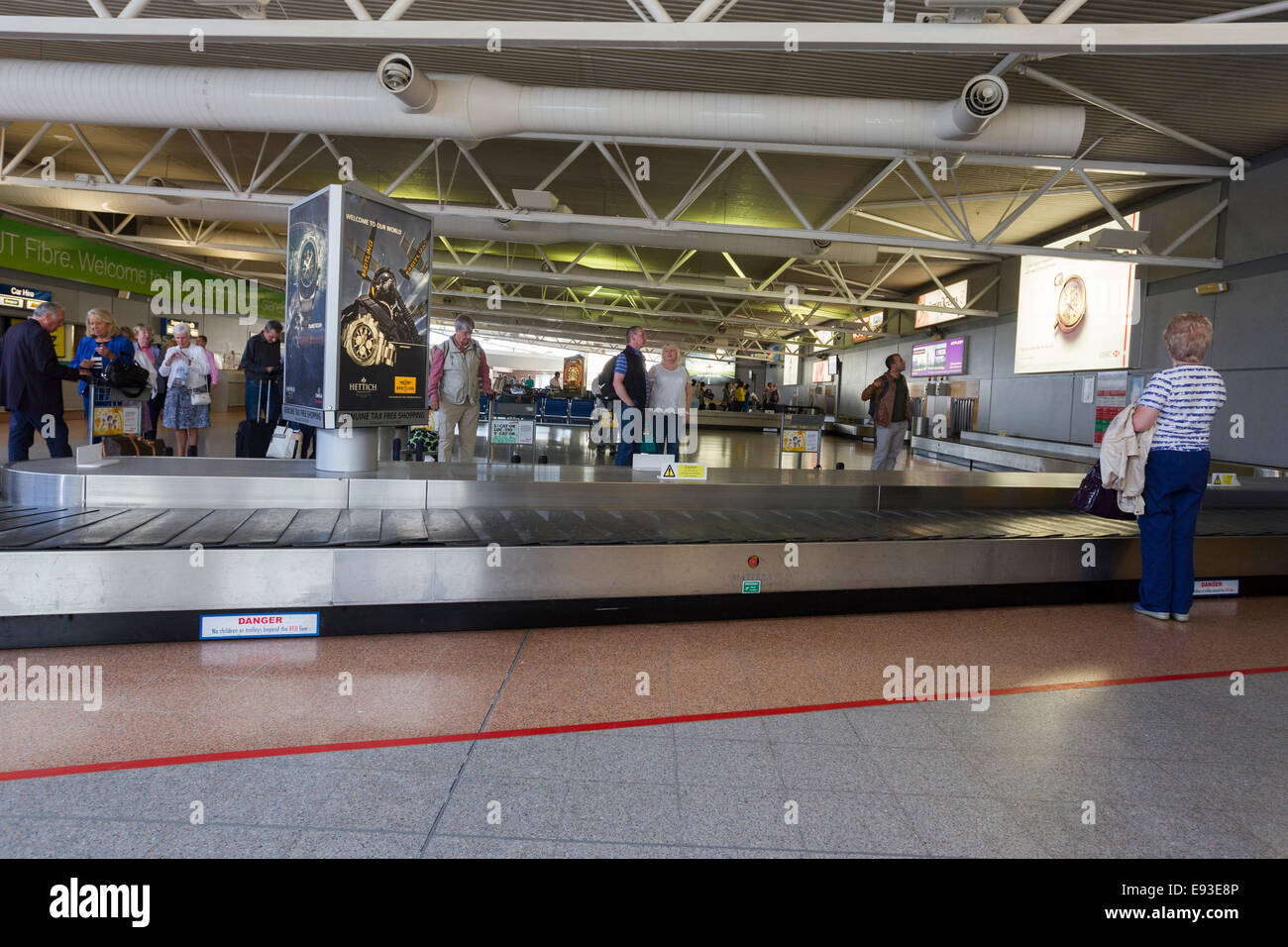 Arrivals waiting for luggage carousel at Jersey Airport The Channel Islands  Stock Photo - Alamy