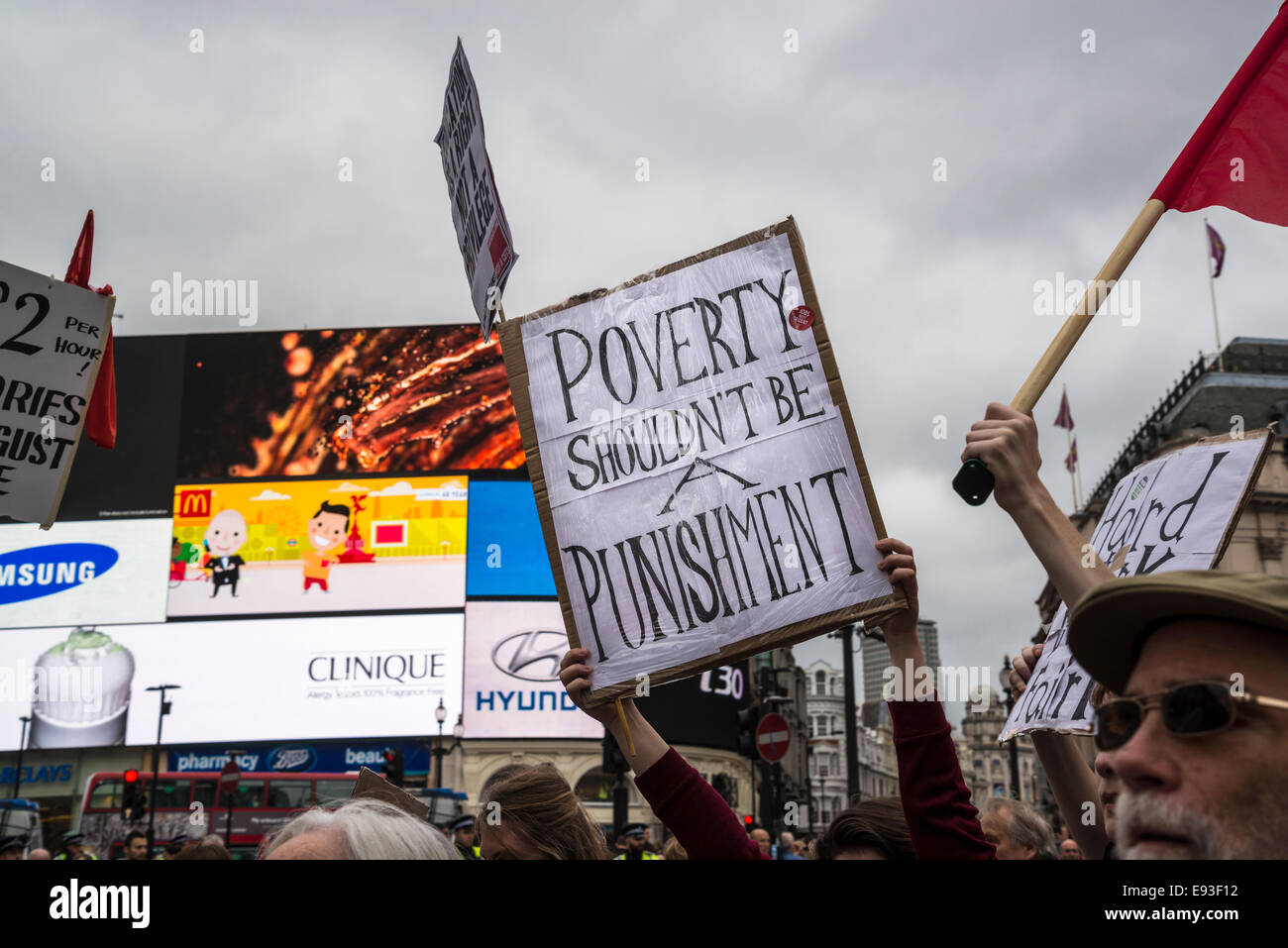 Poverty Shouldn't be a Punishment placard in Piccadilly Circus. Britain Needs a Pay Rise march, London, 18 October 2014, UK Credit:  Bjanka Kadic/Alamy Live News Stock Photo