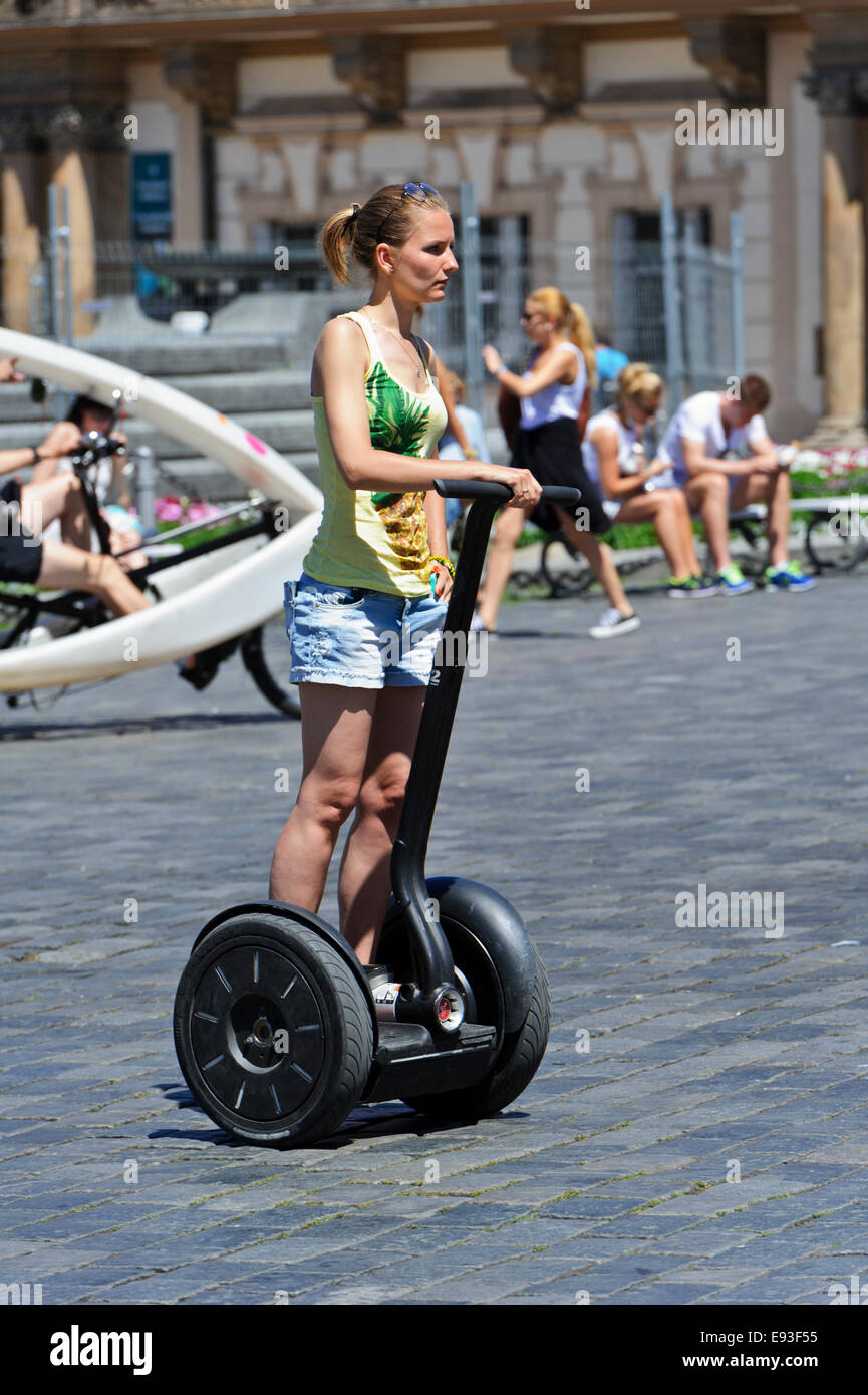 A young woman on a two wheeled motorized Segway on the street of Prague, Czech Republic. Stock Photo