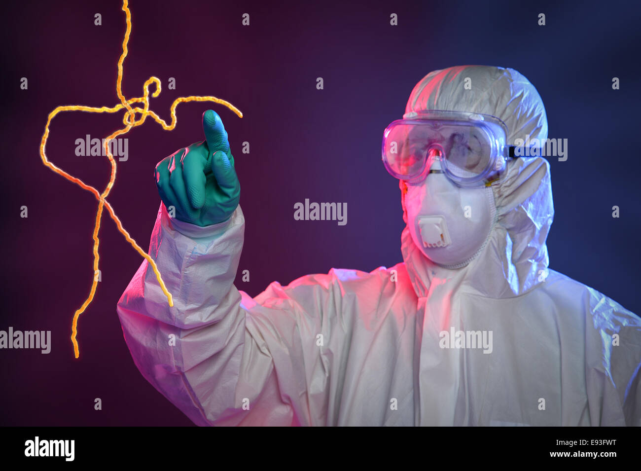 Scientist in Hazmat suit and protective gear pointing at Ebola virus Stock Photo