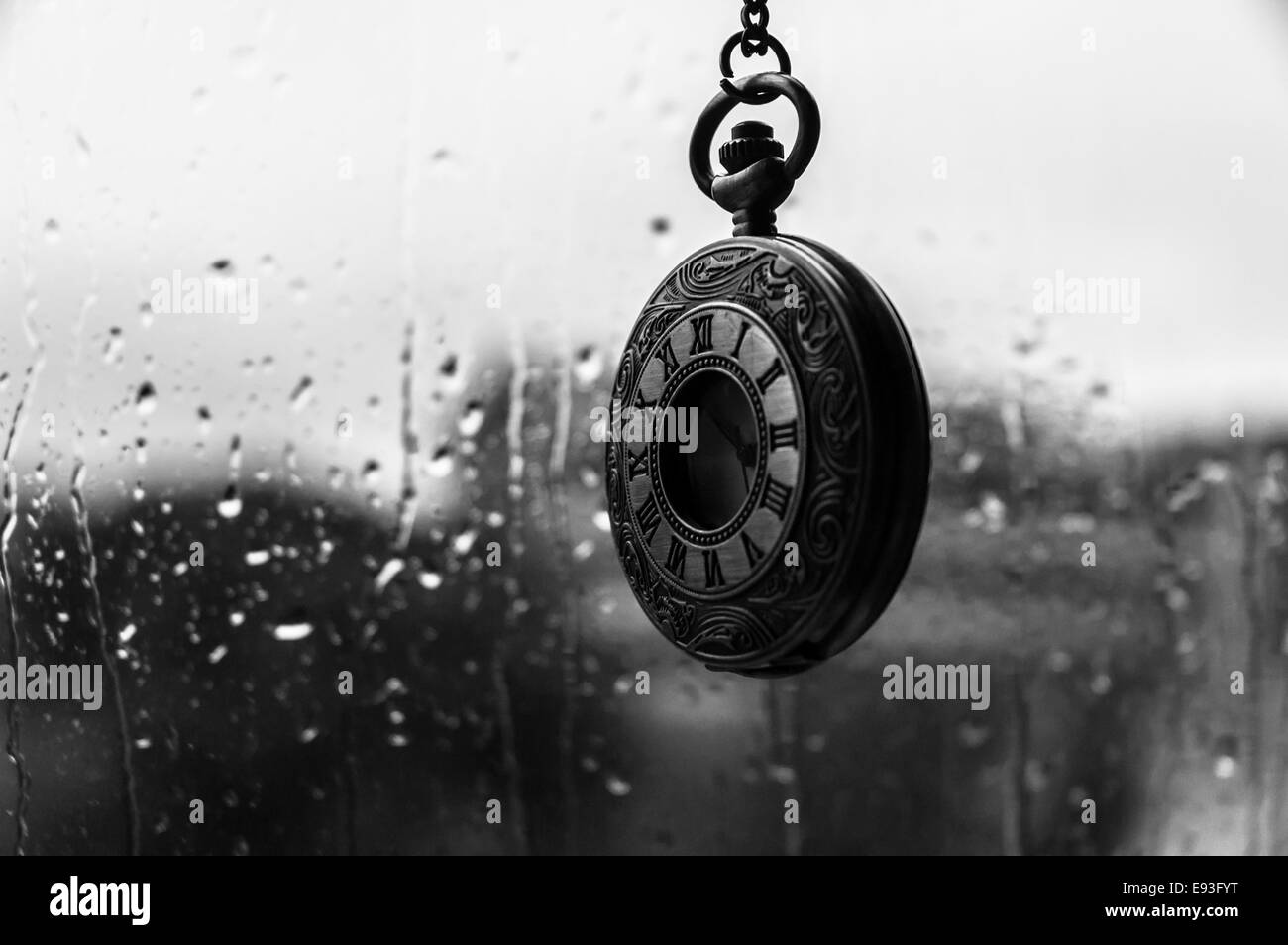 An old antique clock in the rain Stock Photo