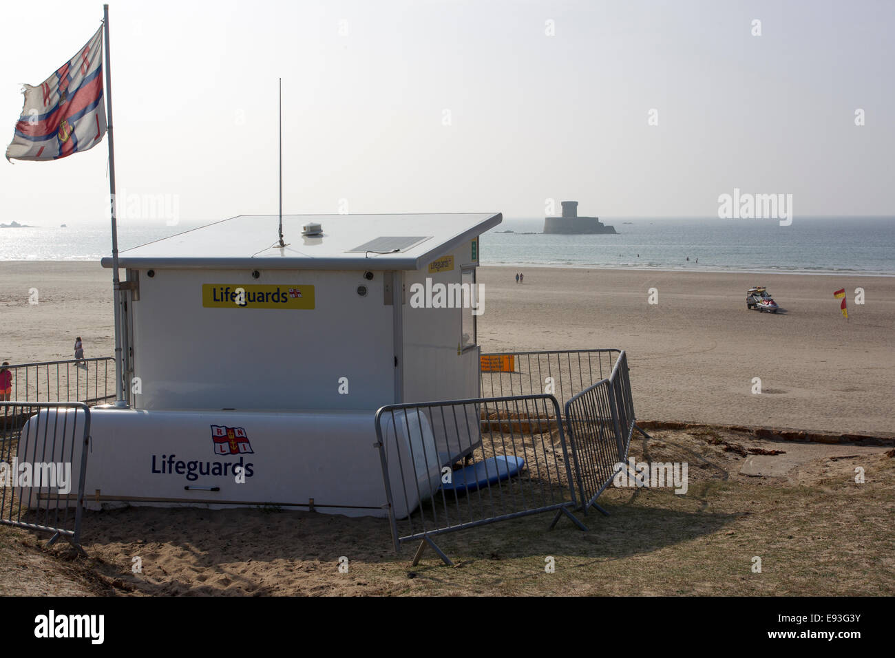 Lifeguards  hut on the south end of  St Ouens Five Mile Beach La Rocco tower Stock Photo