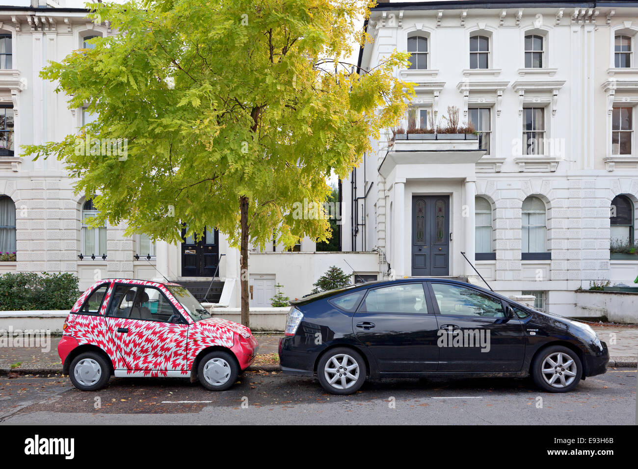 Electric micro car and Hybrid car with a green tree Stock Photo