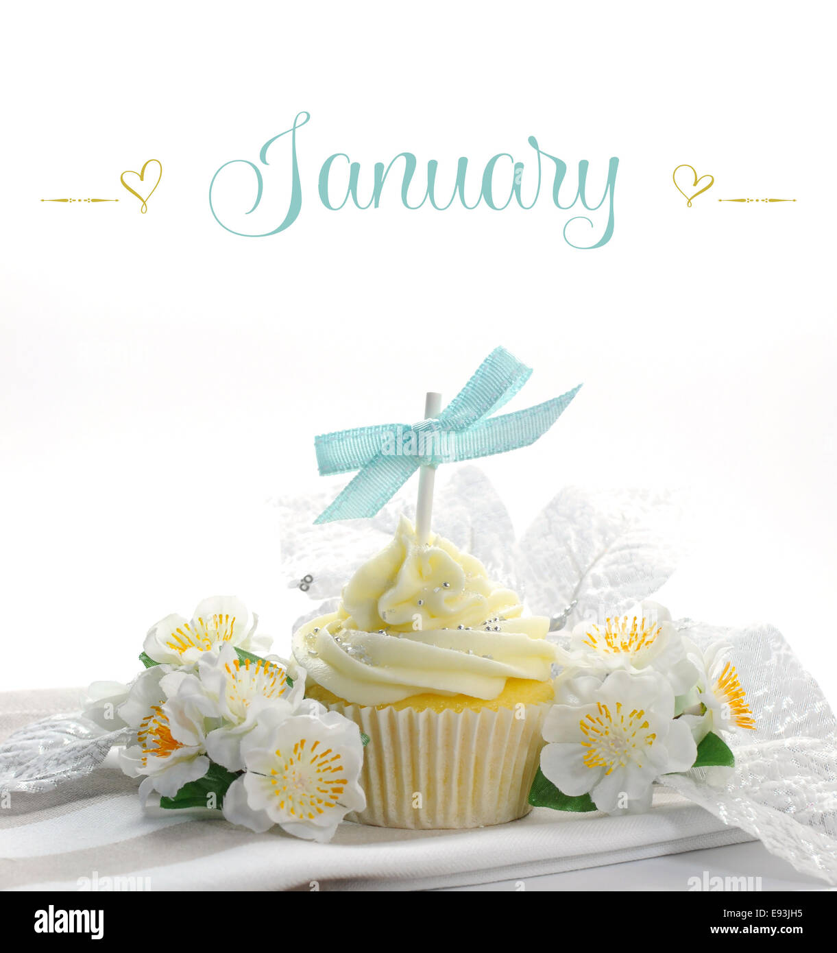 Beautiful white snow theme cupcake with seasonal flowers and decorations for the month of