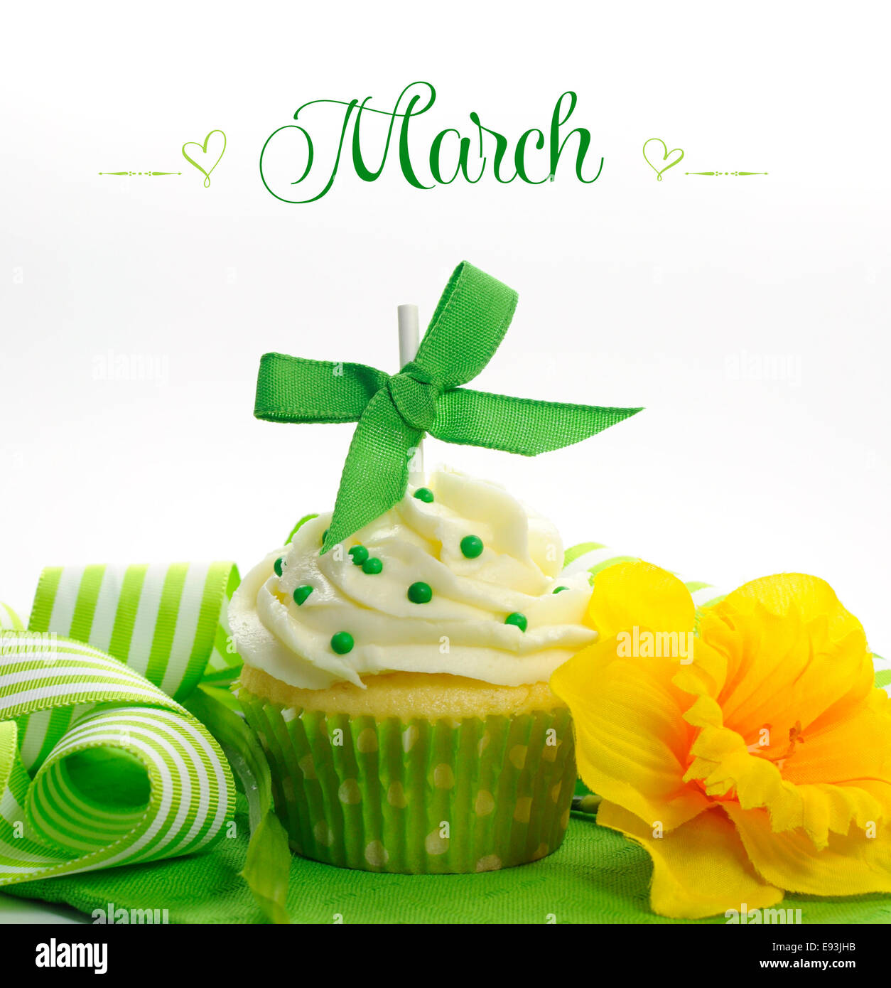Beautiful green and yellow Spring theme cupcake with daffodils and decorations for the month of March Stock Photo