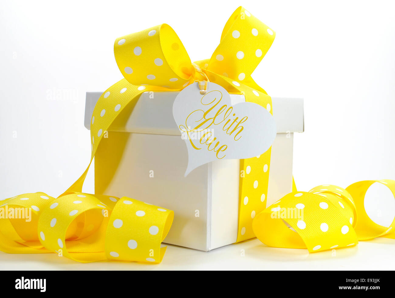 Yellow theme gift box with yellow polka dot ribbon and white box Stock