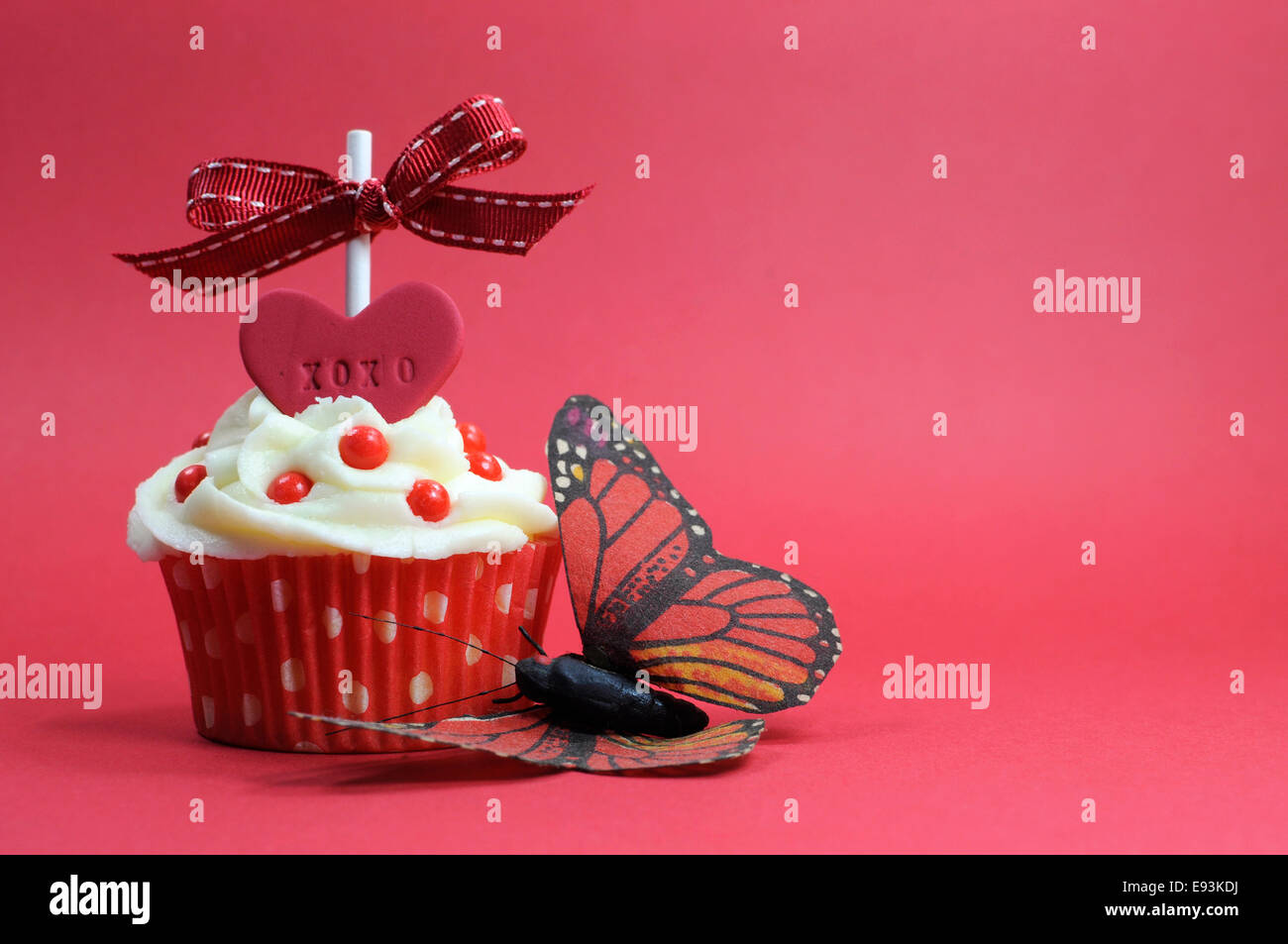 Red theme cupcake with love heart and butterfly on red background Stock Photo