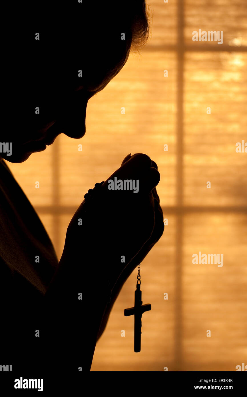 Woman praying with rosary hi-res stock photography and images - Alamy